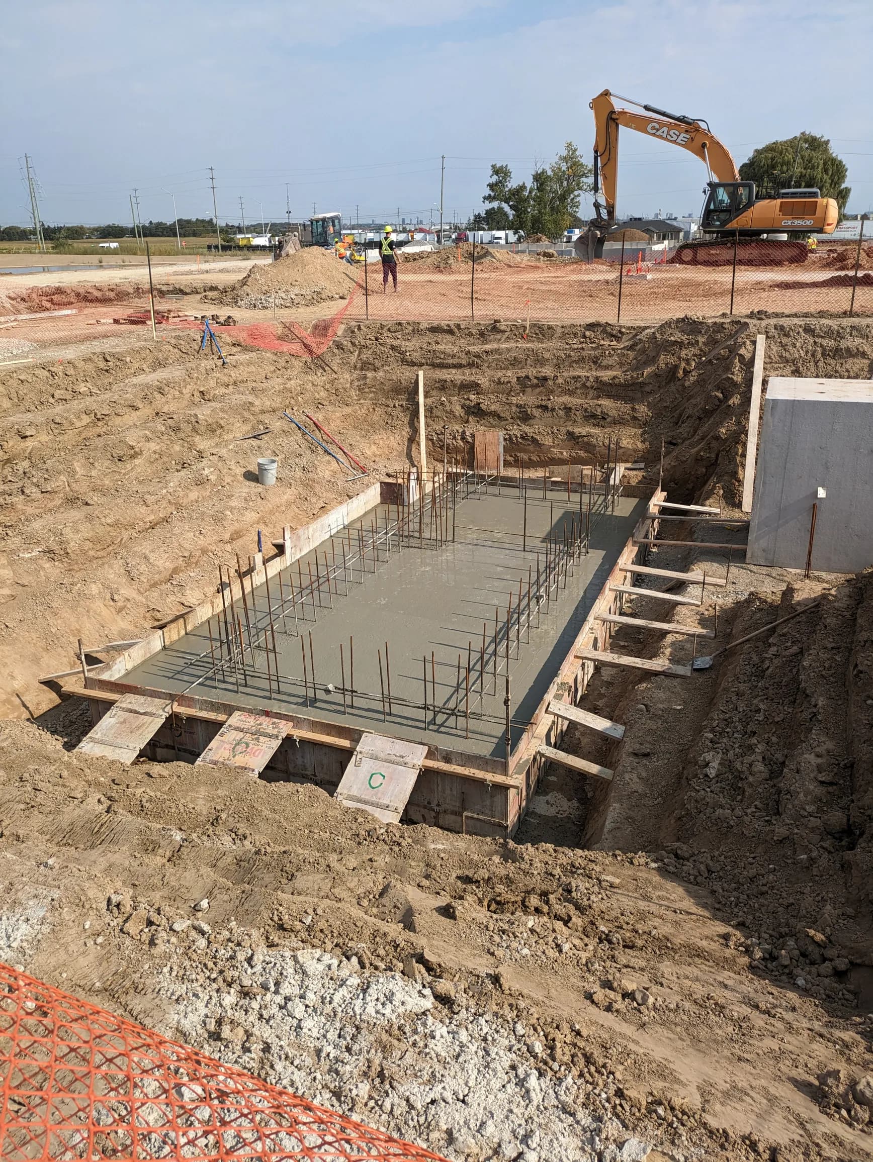 Foundation pour with excavator